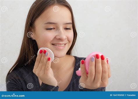 Facial Skin Care A Young Girl Rubs Her Face With A Tonic Nourishing