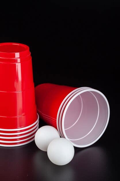 Premium Photo Red Plastic Cups And Ball For Game Of Beer Pong