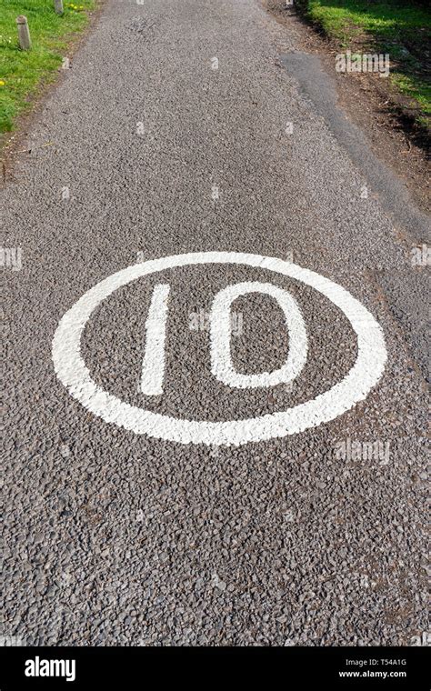 10 MPH speed limit sign painted on road surface Stock Photo - Alamy