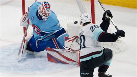 Seattle Kraken's Eeli Tolvanen (20) scores the first goal on Montreal ...