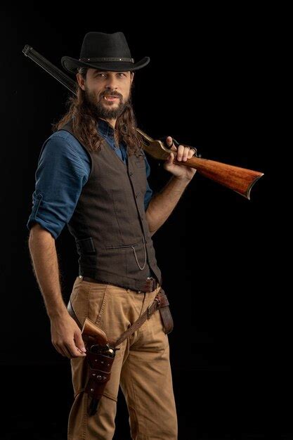 Premium Photo Midsection Of Man Holding Hat Against Black Background