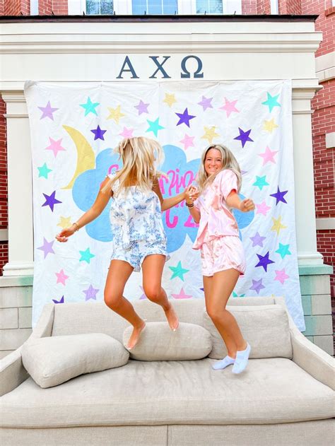 Two Girls Jumping On A Couch In Colorful Pjs Meant To Be Cute Fun