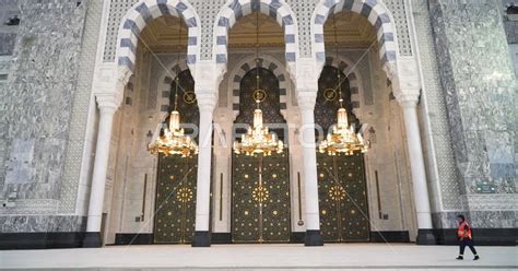 Volunteer man inside the Great Mosque of Mecca in Saudi Arabia, performing Hajj, pilgrims, Umrah ...