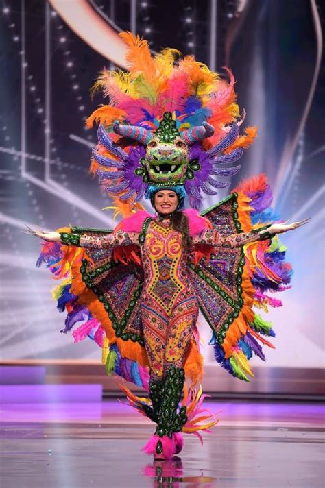 a woman in an elaborate costume on the runway