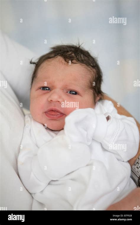 A Newborn Baby In Her Mothers Arms Stock Photo Alamy