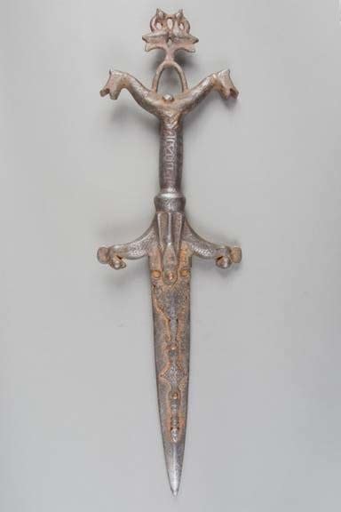 Dagger with intricate hilt representing two schematic riders on horses ...