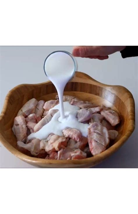 Someone Pouring Milk Into A Wooden Bowl Filled With Meat