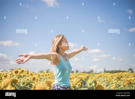 Beauty Sunlit Woman On Yellow Sunflower Field Freedom And Happiness