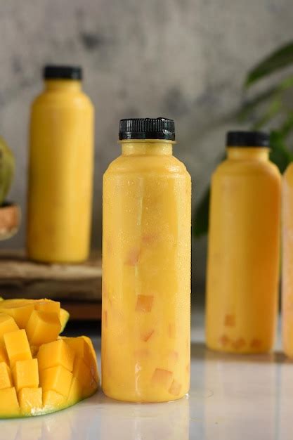 Premium Photo Fresh Mango Juice Mango Juice In A Glass Bottle And Mango Isolated On White