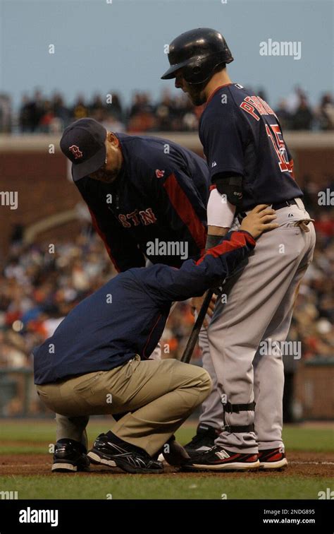 Boston Red Sox S Dustin Pedroia Right Is Tended To By A Trainer Left