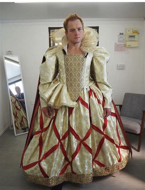 a man dressed in an elaborately designed gown