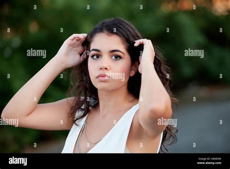 Beautiful Brunette Girl Relaxing In The Park Wiht Many Plants Of Background Stock Photo Alamy