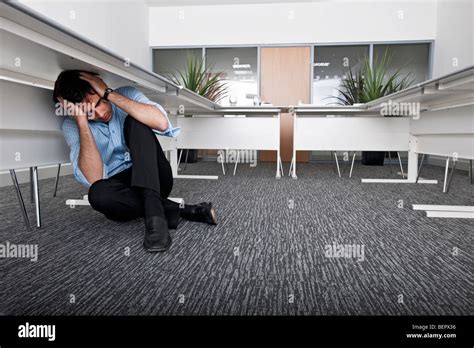 Man Hiding Under Desk Stock Photo Alamy