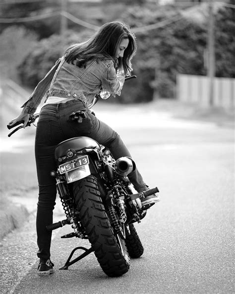 A Woman Riding On The Back Of A Motorcycle