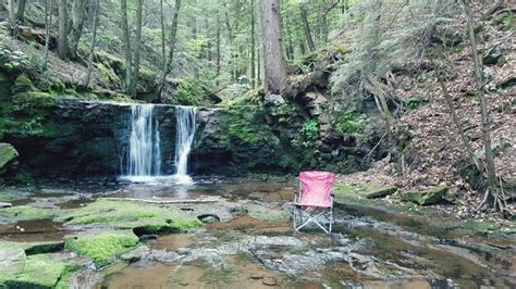 Premium Photo Empty Deck Chair In Stream Against Waterfall At Forest