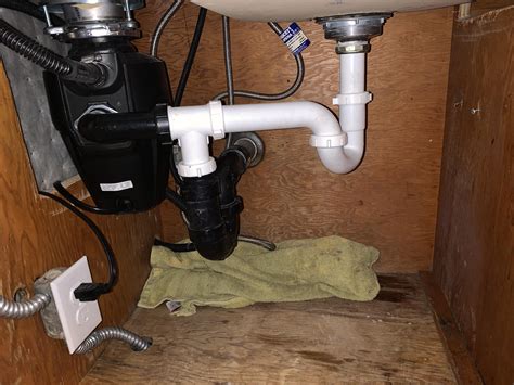 Two p-traps on a double basin sink w/ offset drains and a garbage