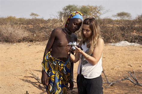 White Woman Showing Her Pictures To A Mucubal Woman Tchitundo Hulo