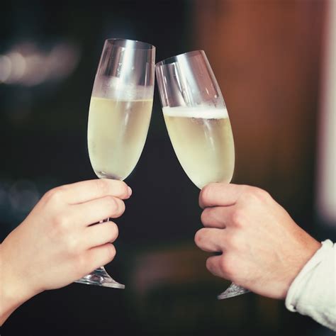 Premium Photo Man And Woman Hands Toasting With Champagne