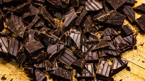 Closeup Of Chopped Dark Chocolate Pieces On A Wooden Surface Stock