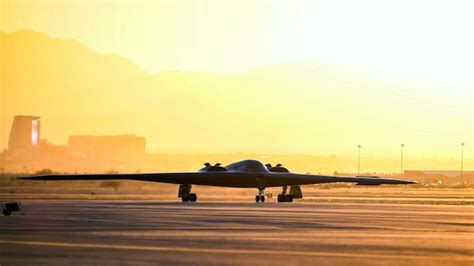 Premium Photo | A b - 2 bomber is shown on the runway at sunset.