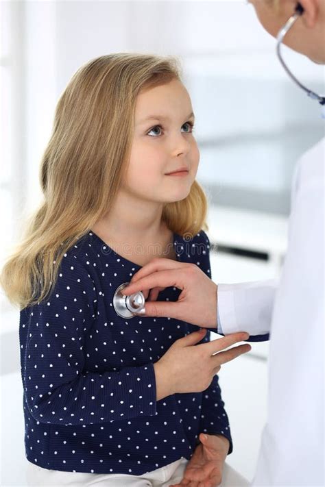 Doctor Examining A Child Patient By Stethoscope Cute Baby Girl At