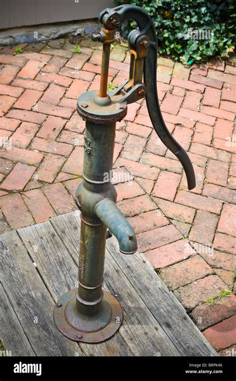 Old fashion outdoor well hand water pump Stock Photo - Alamy