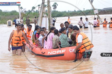 Image Of Ndrf Flood Rescue Team Helping People During Floods In Eluru