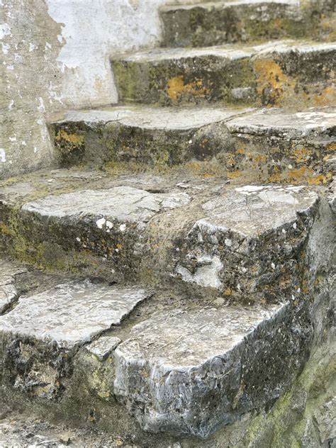 An Old Set Of Stone Steps With Moss Growing On Them