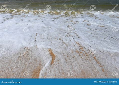 Soothing Waves Crashing On Shore Of Sandy Beach On A Cloudy Day Stock