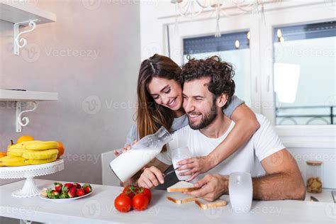 Romantic Young Couple Cooking Together In The Kitchenhaving A Great