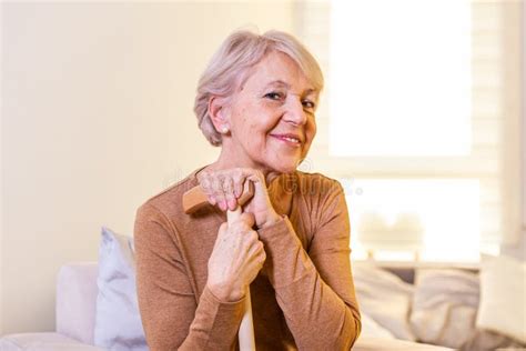 Portrait Of Beautiful Senior Woman With White Hair And Walking Stick