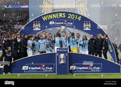 Manchester City Celebrate By Lifting The Trophy After Winning The