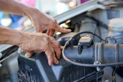 Premium Photo Cropped Hands Of Mechanic Repairing Car In Garage