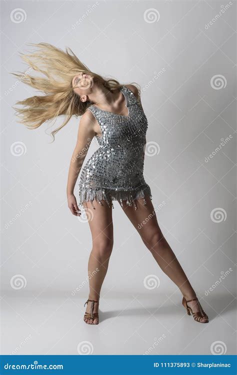 Passionate Woman Dancing And Tossing Long Blonde Hair Stock Image