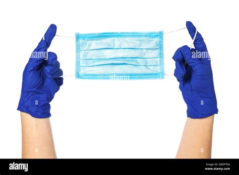 Hands In Rubber Gloves Hold A Protective Medical Mask Surgical Mask