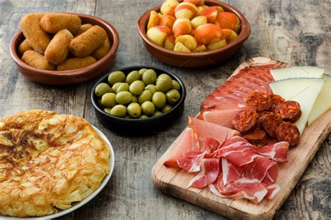 Traditional spanish tapas containing tapas, spanish, and patatas bravas ...