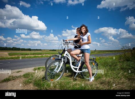 Deux Jolies Filles Sur Tour V Lo Sur Le Chemin De Roche Photo Stock