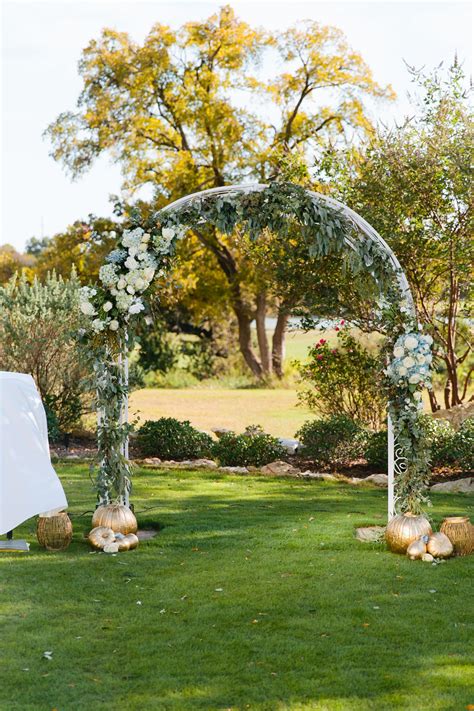 Outdoor Wedding Arch Draped with Hydrangeas, Roses and Greenery