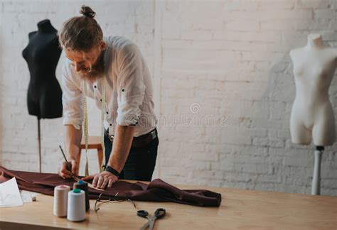 Homem Farpado Que Inclina Se Em Cima Do Worktable Imagem De Stock