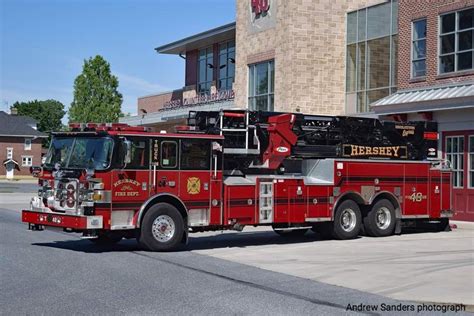 A Red Fire Truck Parked In Front Of A Building