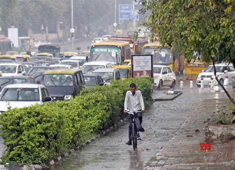 New Delhi: Vehicles ply on a road amid heavy rainfall, in New Delhi ...