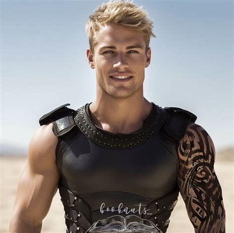 a man with tattoos on his arm and chest standing in the desert wearing a leather outfit