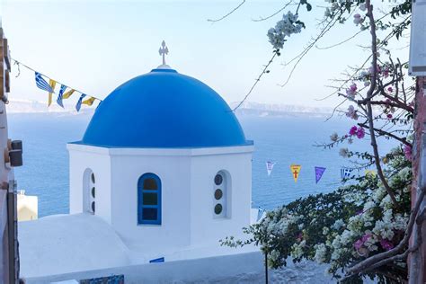 The Famous White Village Of Oia With The Blue Domes On The Greek Island