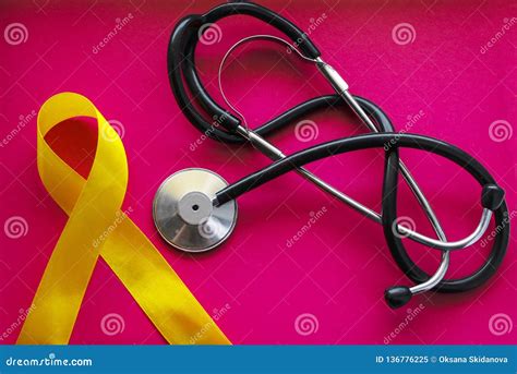 Golden Ribbon And Medicine Concept A Symbol Of Childhood Cancer