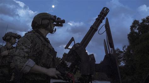 US Navy SWCC Crewman on a SOC-R vessel armed with a 7.62 NATO minigun ...