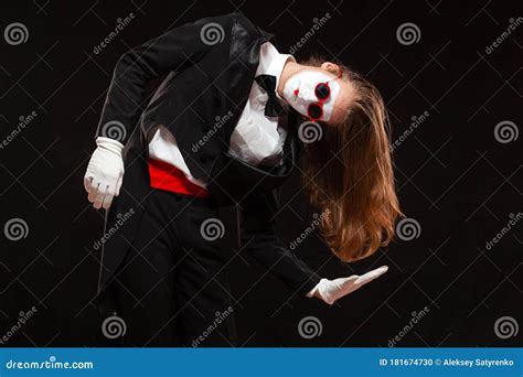 Portrait Of Male Mime Artist Performing Isolated On Black Background