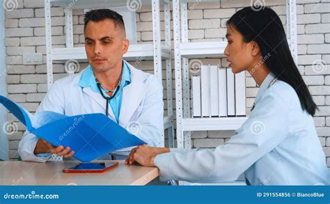 Doctor in Professional Uniform Examining Patient at Hospital Jivy Stock Photo - Image of smiling ...