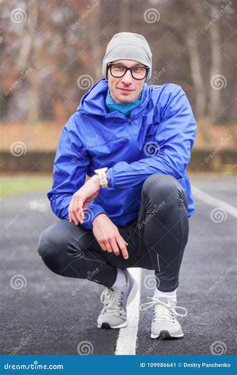 Shot Of A Young Handsome Professional Runner Looking At Camera Stock