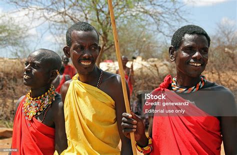 Three Traditionally Dressed Masai Tribesmen Welcome Visitors Stock Photo - Download Image Now ...