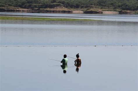 Premium Photo | Man and woman fishing in lake